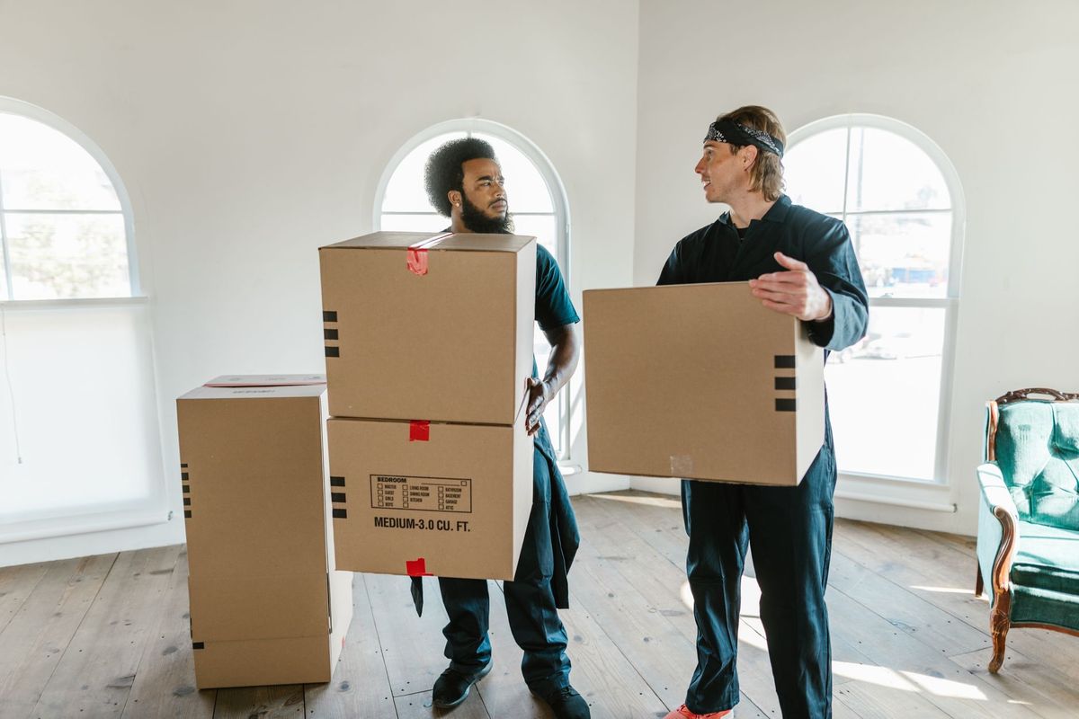 Neighbor's Best Moving Company team carefully packing fragile dishes for an Inland Empire move