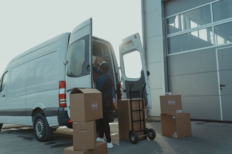Movers carefully carrying packed boxes during a residential move