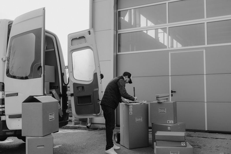 Experienced moving crew carefully loading boxes into a moving truck